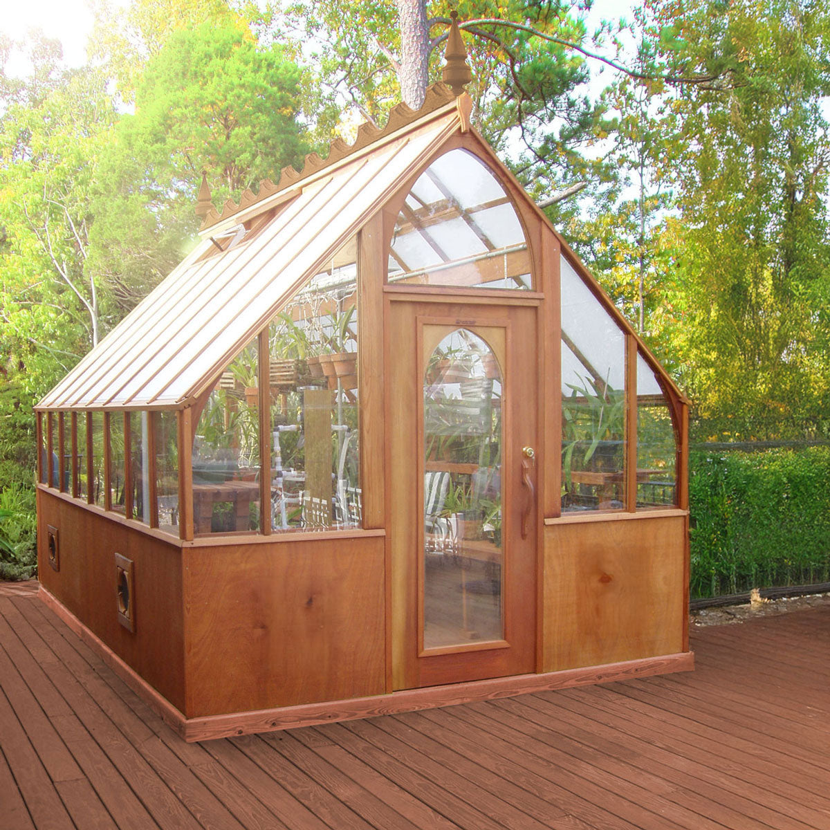 Tudor Greenhouse with side entry door and curved ridge detail.