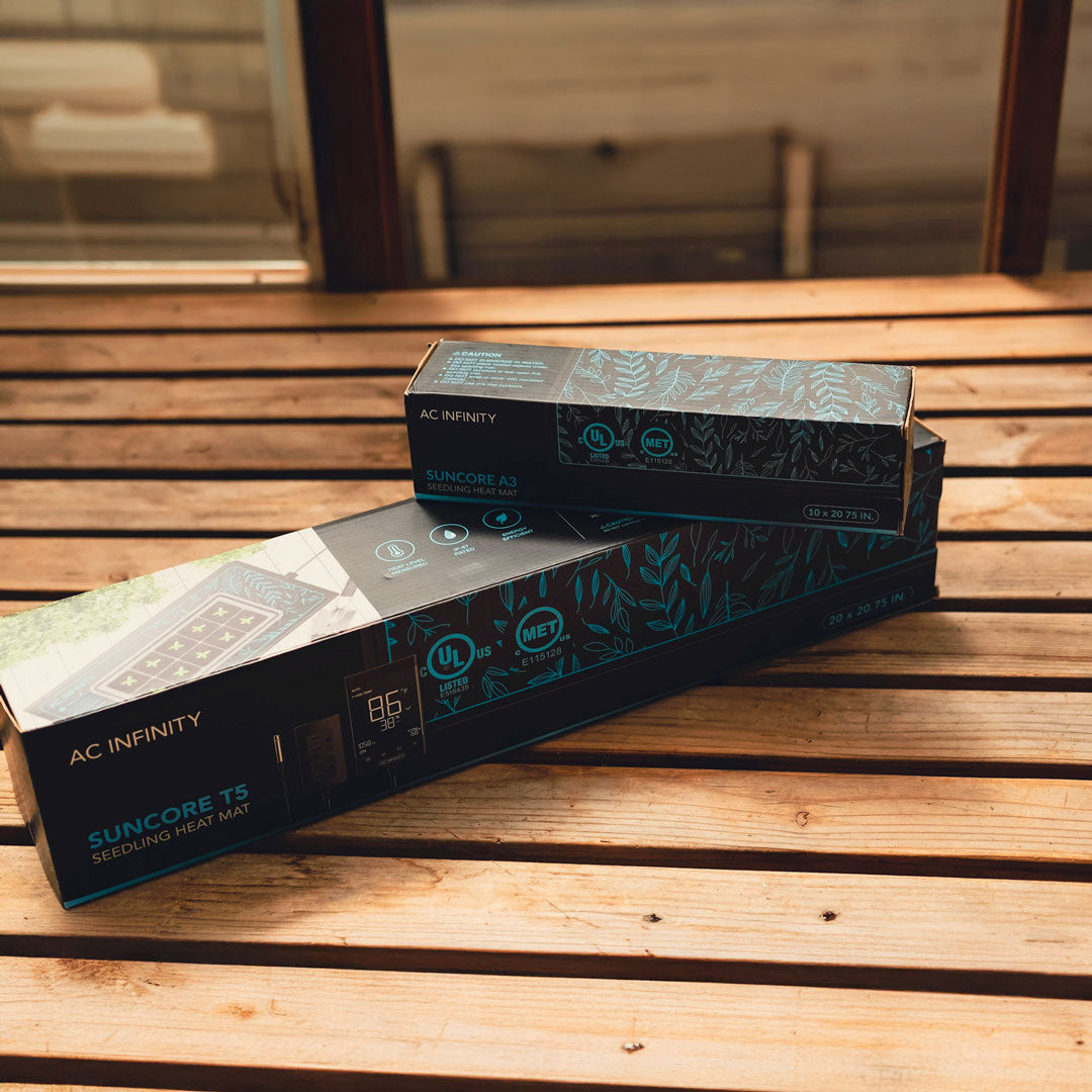 Two boxes of AC Infinity Suncore T3 heat mats on a wooden surface