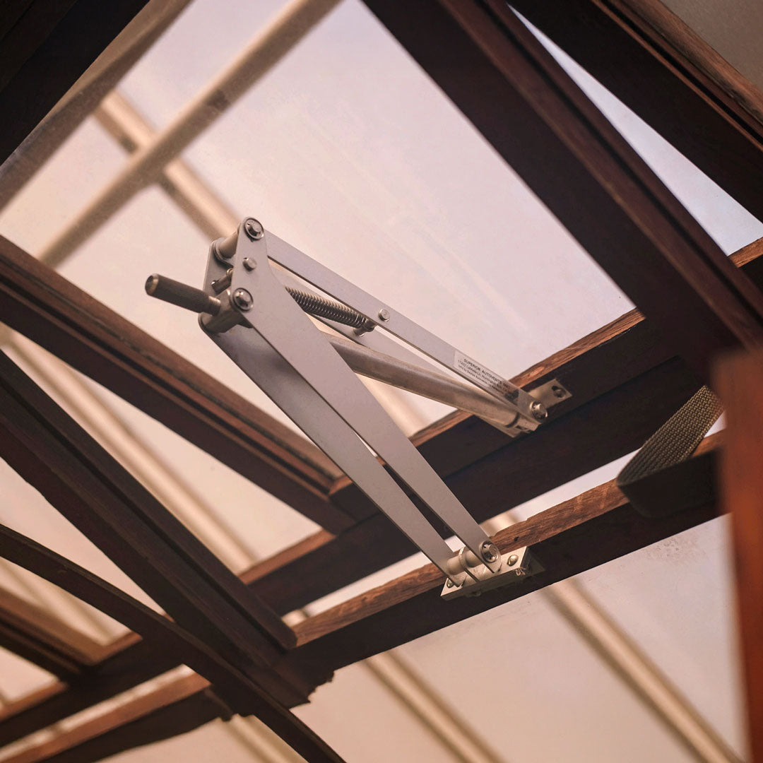 Metal folding stand against a window with natural light