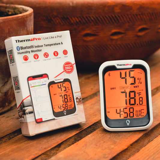 Thermopro digital thermometer with packaging on a wooden surface