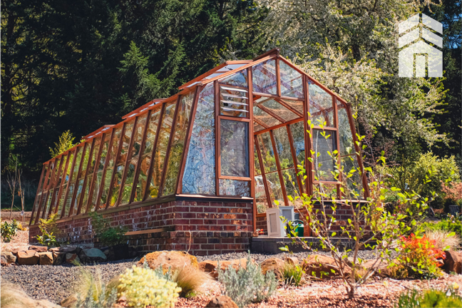Redwood and glass luxury greenhouse in a landscaped backyard