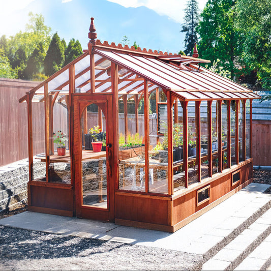 Wooden Artisan greenhouse with glass panels in a backyard setting