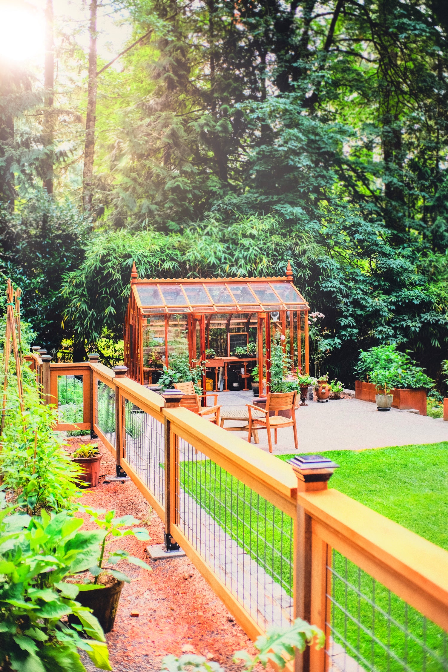 Backyard with wooden deck, gazebo, and lush greenery