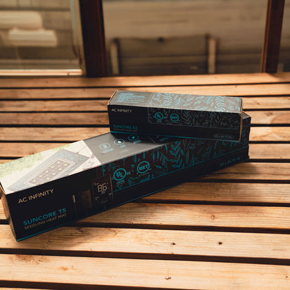 Two boxes of AC Infinity Suncore T3 heat mats on a wooden surface