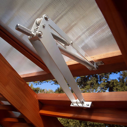 Metal patio door opener attached to a glass door with wooden frame, outdoors.