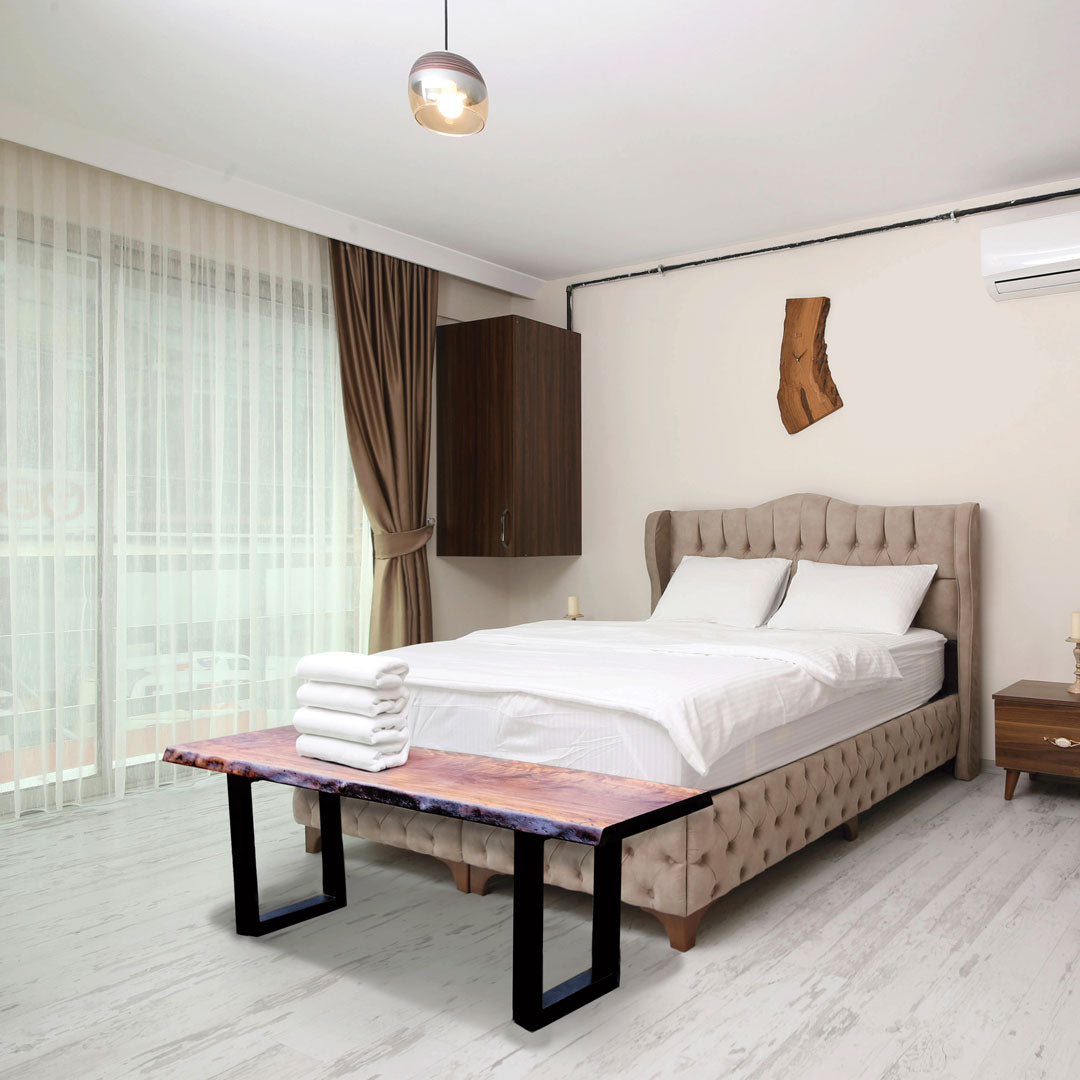 Modern bedroom with a bed, bench, and decorative elements.