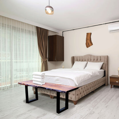 Modern bedroom with a bed, bench, and decorative elements.